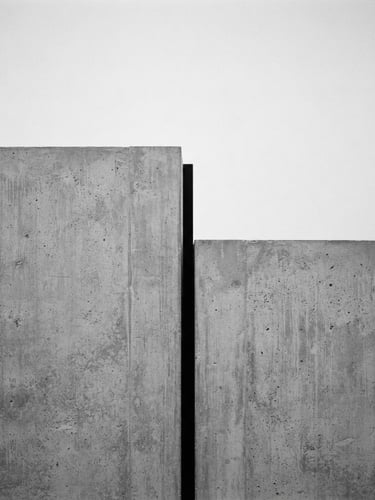 Straight-on orthographic crop of a minimalist black and white architectural photograph, showing sharp concrete lines and fine silver halide grain, diffused gallery lighting.