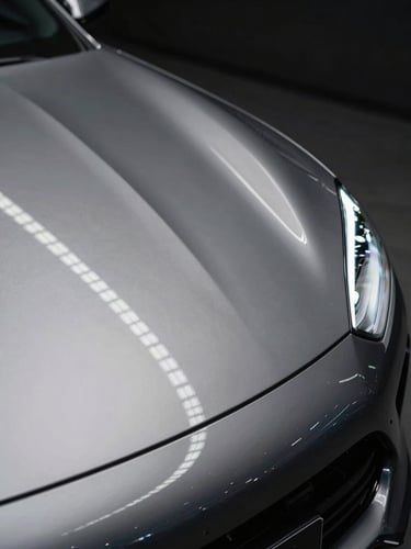 Macro shot of linear overhead LED strip reflections on a flawless metallic car body panel, showcasing perfect curves and laser-straight alignment, dark high-contrast studio lighting.
