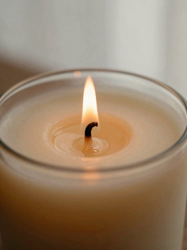 Close-up macro shot of a hand-poured soy candle with a delicate cotton wick flame, focusing on the rich creamy texture of melting wax, warm earthy tones, soft CDMX afternoon light.