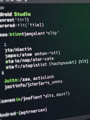 Close-up macro shot of Android Studio code on a dark monitor, showing clean, optimized Java/Kotlin syntax, with a subtle green ambient glow reflecting on the screen, crisp studio lighting.