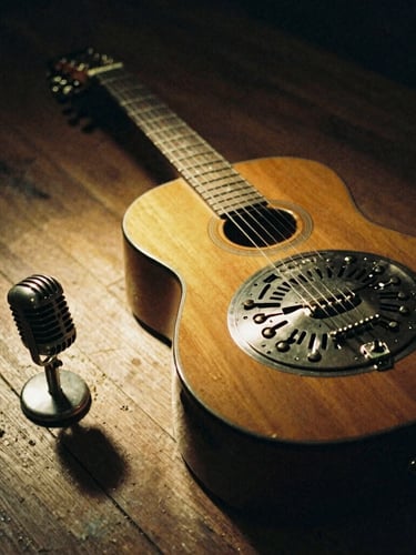 Close-up of a hand-worn resonator guitar and vintage microphone resting on dusty floorboards, warm side spotlight, low-lit room, 35mm film grain.