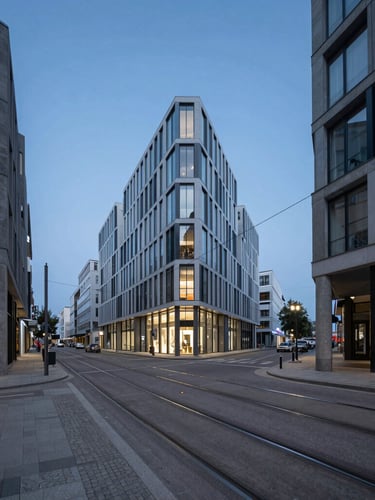 Crisp architectural photography of a modern European city street at blue hour, sharp perspective lines, tram tracks in the foreground, minimal desaturated urban tones