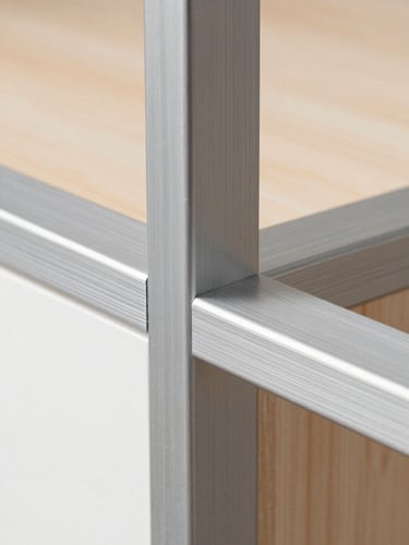 Macro detail shot of a seamless brushed aluminum joint on a modular cabinet frame, sharp focus, clean metallic textures.