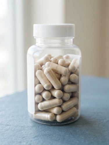 Close-up of clean Re-Life OA supplement capsules in a minimalist white bottle, bright natural daylight, soft shadows, on a slate blue surface, 50mm lens.