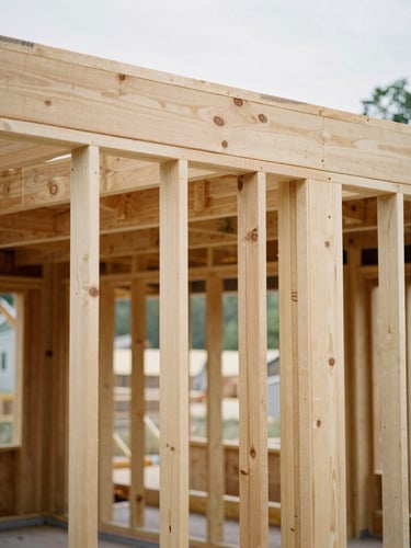Detailed close-up of heavy timber joinery on an active but orderly Maryland residential construction site, natural daylight, crisp structural lines