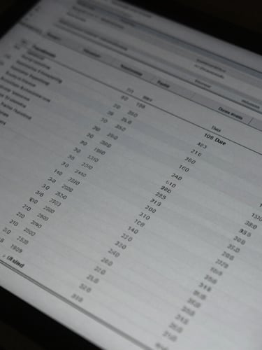 Close-up of structured data on a dark screen in a low-key corporate environment, cool desaturated tones, sharp focus, 35mm