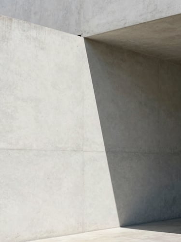 Minimalist architectural corner with sharp intersecting shadows on a clean light concrete wall, soft natural daylight, high contrast, conveying structure and clarity.