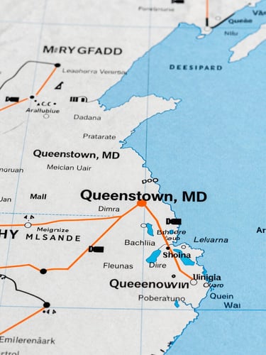 Detailed map highlighting the Mid-Atlantic region (Maryland, Delaware, Virginia, Pennsylvania) with Queenstown, MD marked as the central hub, crisp technical lines.