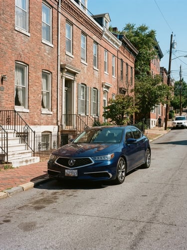Bright natural daylight, crisp editorial photo of a clean modern sedan parked along the historic brick facades of Paca Street in Baltimore, 35mm