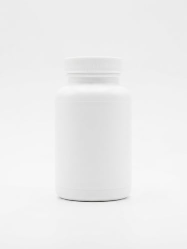 Centered product packaging shot of DentaBiome supplement bottle on a clean white laboratory backdrop, bright high-key studio lighting, sharp focus, clinical aesthetic, 50mm