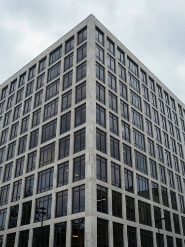 Symmetrical wide shot of a modern corporate building exterior in Wilmington, cool overcast daylight, sharp architectural lines.