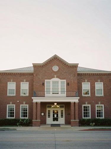 Wide environmental portrait of a historic brick community center in soft morning daylight, muted warm tones, 35mm film style