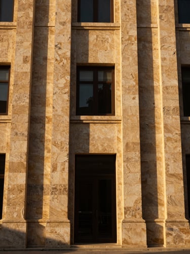 Symmetrical architectural low-angle shot of a premium stone facade in Damascus at golden hour, deep shadows, rich gold tones, elegant medium format photography.