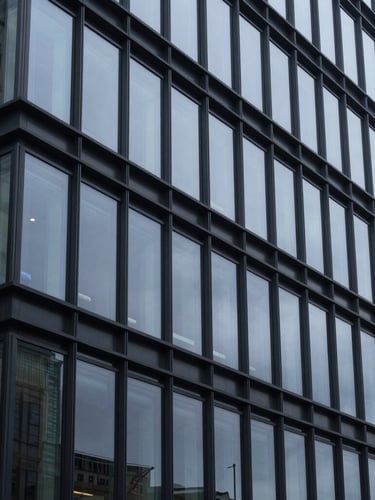 Macro perspective of architectural glass and clean structural lines of a modern financial institution, cool overcast daylight, sharp focus, deep slate tones, 35mm