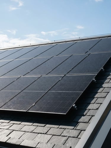 Sharp architectural photography of modern solar panels on a clean slate roof, bright natural daylight, high contrast, 35mm