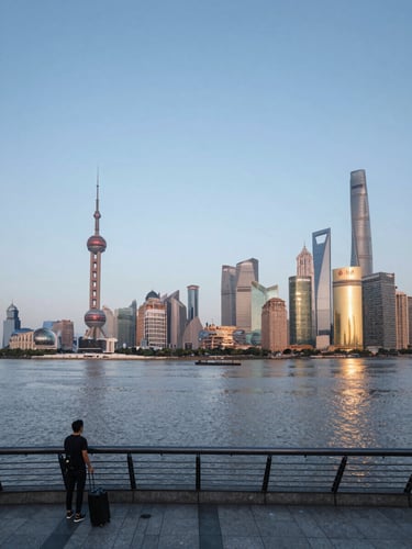 Wide panoramic view from the Bund in Shanghai at early morning, Pudong skyline across the Huangpu River to the right, calm water reflecting blue-grey dawn light, a lone traveler with a rolling suitcase on the promenade in the left foreground, generous empty sky above