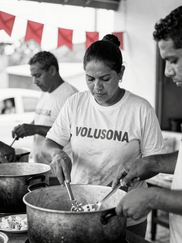 Documentary portrait of community kitchen volunteers in Rio de Janeiro preparing meals in a large pot, warm natural light, high-contrast black and white with subtle red flags in the background, authentic 35mm photography.