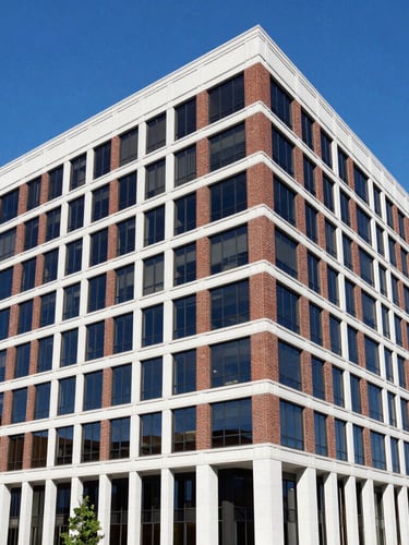 Professional editorial photography of a modern commercial brick office building in downtown Memphis, bright natural daylight, deep blue sky, clean architectural lines, sharp focus, 35mm lens.
