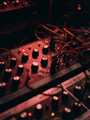 Cinematic close-up of analog musical gear in a dark studio, harsh red neon light reflecting on metallic dials, heavy film grain, 35mm lens
