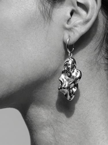 Close-up macro shot of a sculptural silver earring on clean skin, sharp studio lighting, deep shadows, high-contrast monochrome editorial style, 35mm
