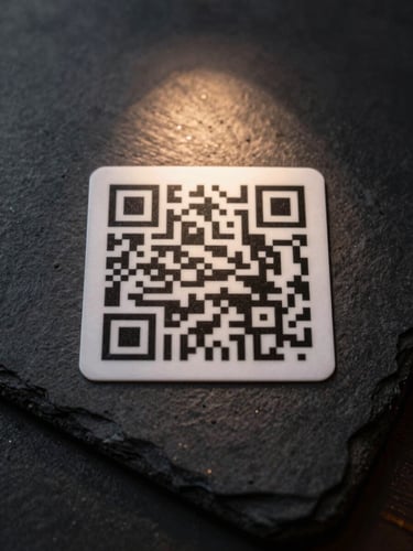 Extreme close-up overhead of a dark slate restaurant table surface, a single printed QR code card centered in frame under a narrow beam of warm directional light, the code's geometric grid sharp and precise, deep shadows surrounding—studio strobe, high contrast, no hands or people visible