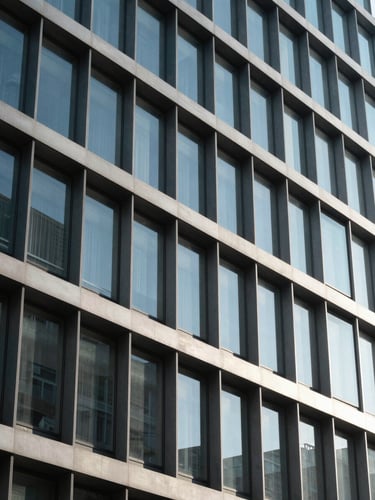 Precise architectural close-up of a glass and steel financial building facade in Madrid, clean geometric patterns, sharp shadows, cool blue daylight reflections.