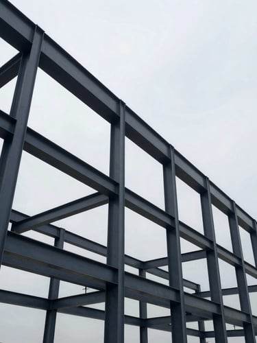 Crisp architectural photography of massive modern structural steel framing under a cool overcast sky, high-contrast structural geometry, deep slate and steel tones, wide-angle lens
