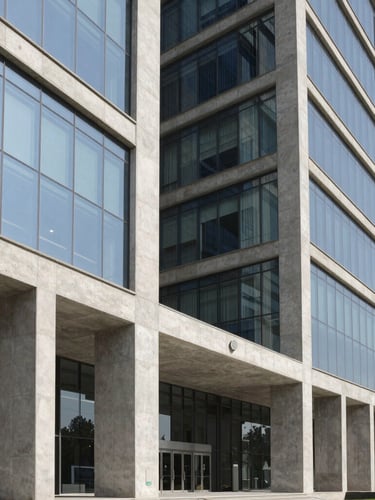 Crisp architectural photography of a modern concrete and glass corporate headquarters in Islamabad, sharp daylight, deep shadows, 35mm lens.