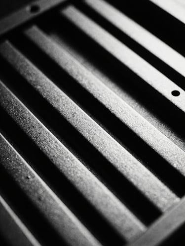 Macro close-up of high-end computer hardware chassis, sharp architectural lines, dramatic key light, stark monochrome tones, 35mm film grain