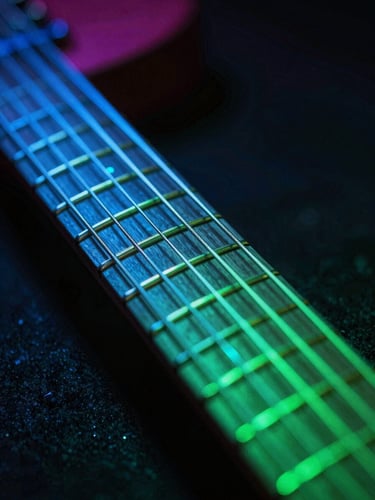 Extreme close-up of a high-end electric guitar fretboard illuminated by neon electric-blue and laser-green backlighting, fingers pressing on strings, dark moody background, 35mm lens
