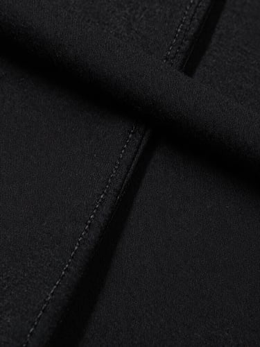 Close-up of thick, heavy-weight black cotton fabric seams, sharp studio lighting highlighting the dense texture and clean stitching