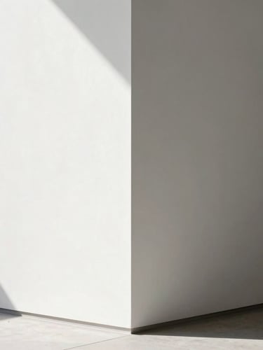 Minimalist architectural interior showing a perfectly aligned drywall corner with crisp shadows, clean white paint, geometric lines, natural side lighting, high-definition detail