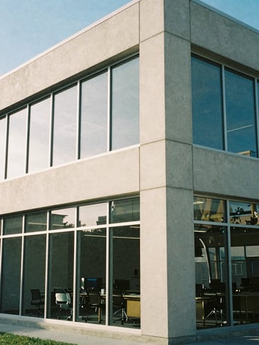 Architectural detail of a modern concrete and glass workspace in Salt Lake City, soft morning daylight, cool shadows, editorial film photography, 35mm lens