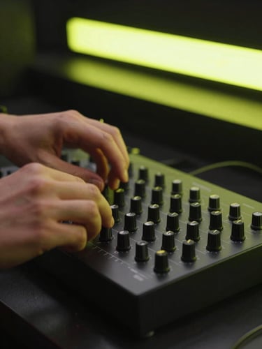 Close-up of hands adjusting dials on a modern MIDI controller, illuminated by a sharp cyber-lime neon screen glow in a dark studio setting.