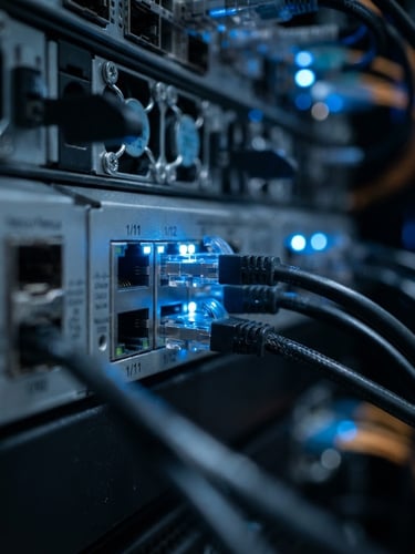 Crisp macro photograph of a server rack with cool blue status lights reflecting on clean metallic ports, shallow depth of field