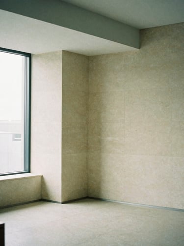 Architectural detail of a minimalist limestone office interior, clean geometric lines, soft diffused daylight, muted green shadows, editorial aesthetic.