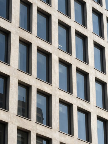 Architectural detail of a modern, clean corporate headquarters facade under bright natural daylight