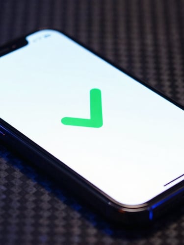 A close-up shot of a smartphone screen displaying a diagnostic green checkmark, resting on a dark carbon fiber surface with electric blue highlights