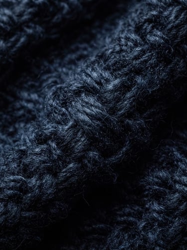 Macro close-up of a deep navy-blue heavy cotton weave, showing high-density zero-tension yarn under high-contrast directional studio lighting, rich shadows