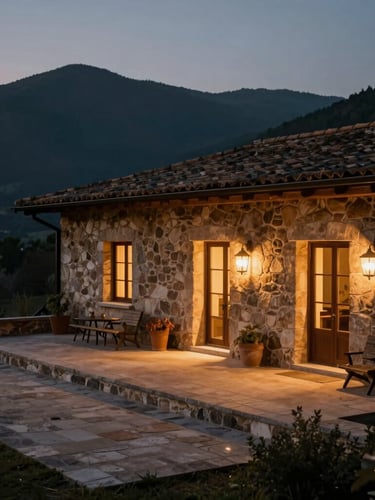 A remote stone villa at dusk, warm interior lighting casting a soft glow onto an empty terrace, vast dark mountains in the background, cinematic 35mm.