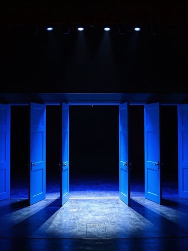 Wide-angle dramatic production photography of an empty arena stage right before doors open, glowing with electric blue lighting, deep shadows, sharp focus, 35mm.