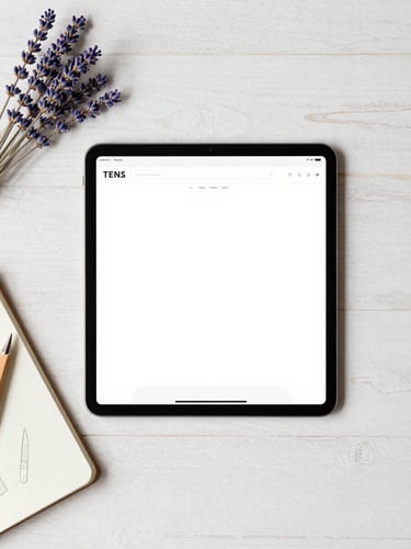 Overhead flat-lay of a clean wooden desk with a tablet showing a simple website layout, a notebook with pencil sketches, soft natural daylight, lavender accents, 35mm