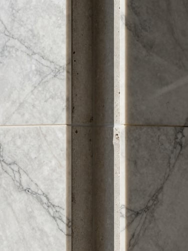 Symmetrical close-up of premium marble finishes meeting raw concrete in a luxury Rio residence, dramatic natural side lighting, extreme precision
