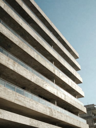 Extreme low-angle architectural perspective of a modern concrete and glass residence in Rio de Janeiro, sharp geometric shadows cast by dramatic coastal daylight, clean composition.