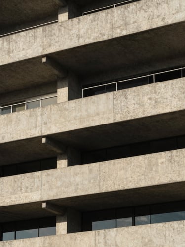 Geometric close-up of a modern concrete building facade in Rio de Janeiro, sharp shadows, dramatic natural coastal daylight, architectural lines.