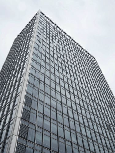 Wide-angle architectural perspective of a minimalist glass and steel skyscraper facade in Wilmington, sharp overcast daylight, clean geometric lines.