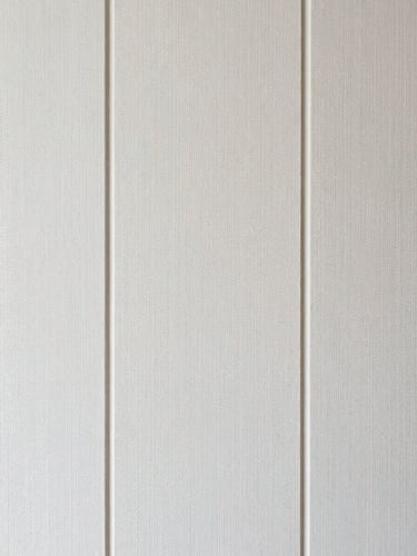 Straight-on shot of perfectly aligned luxury wallpaper seams, bright natural lighting.