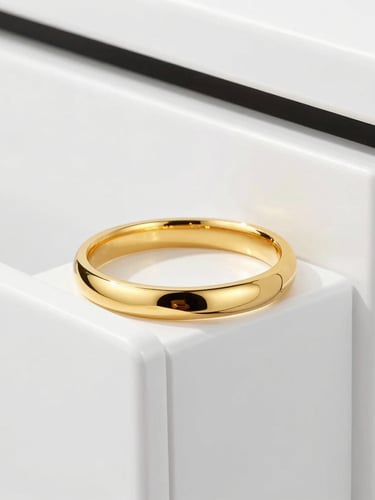 premium studio photography, bright high-key lighting, close-up of heavy gold jewelry resting on a clean modern white vault door, metallic gold reflections, sharp focus, 85mm
