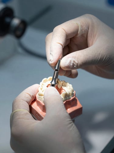 A tight macro shot of hands-on training, sterile surgical gloves adjusting a titanium implant fixture on a high-precision dental model, cool clinical lighting