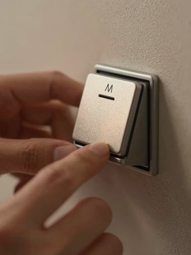 Macro close-up of hands calibrating a flush-mounted architectural dimmer keypad, warm low-temperature light highlighting the tactile metal finish, shallow depth of field.
